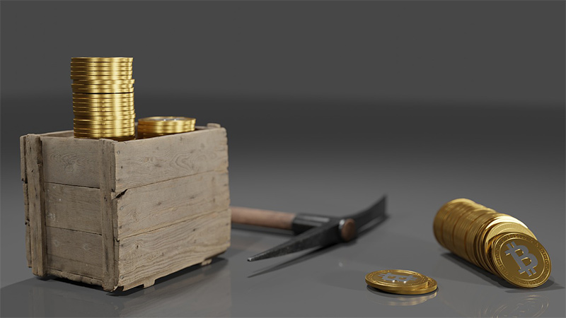image of a mining pick and some bitcoins
