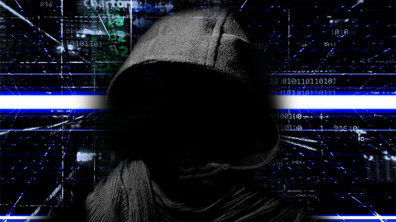 Picture of a hooded hacker. (A representation of the deribit hot wallet hack). 