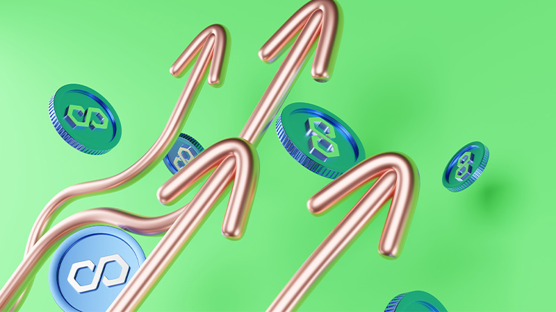 image of blue MATIC coins on top of a green background. MATIC is the native token of the polygon blockchain. 